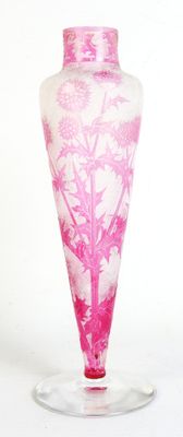 a pink vase with a tree on it on a glass stand