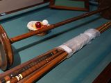 a pool table with a pool cues and balls on it