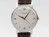 a close up of a wrist watch with a brown leather strap