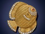 a gold and diamond fish broochle