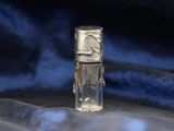 a small bottle of perfume sitting on a blue cloth