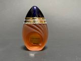 an image of a bottle of perfume sitting on top of a table