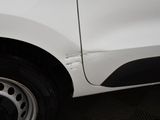 a close up of a white car with a damaged tire