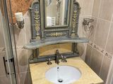 a bathroom with a sink, mirror, and shower in it