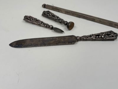 four different types of knives and a knife holder on a white surface