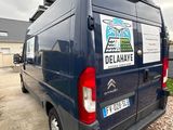a van that is parked on the gravel road