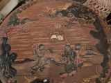 a wooden table with a black and gold design on it