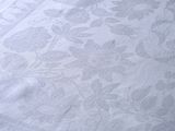 a close up of a bed with a white comforter on it