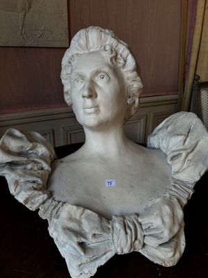 a statue of a woman with a bow around her neck