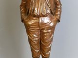 bronze statue of a boy with a bow on his head