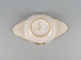 underside view of a porcelain bowl with a gold rim and floral decoration