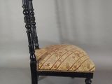 a black chair with a patterned seat and back