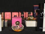 many different types of perfumes on a black table
