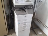a white printer that is sitting on top of a cabinet