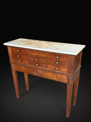 an image of a wooden chest of drawers with marble top