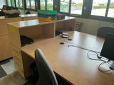 a desk with a computer and a chair in front of it