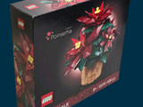 a box with a lego poinsettia in it on a blue background