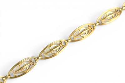 a close up of a gold bracelet on a white background