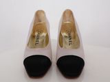 a pair of chanel shoes with black and white heels