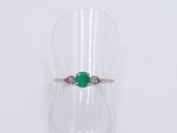 an image of a ring with a green stone on it
