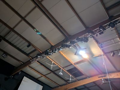 a picture of a stage with a projector screen and a projector screen