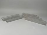 three clear plastic containers are lined up on a white surface