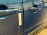 a close up of a car door handle with a sticker on it