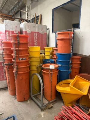 many buckets of different colors and sizes in a warehouse