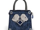 a blue handbag with two lions on the front and a heart on the back