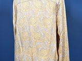 a yellow shirt on a mannequin stand against a blue background