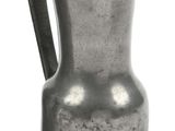 a silver pitcher with a handle on a white background