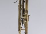an old brass trumpet hanging from a string on a wall