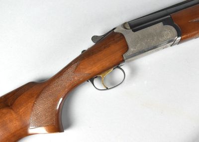 a close up of a rifle on a table with a white background