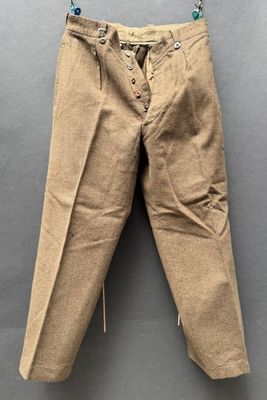 an old pair of pants hanging on a hanger