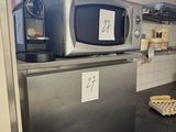 a small kitchen with a microwave and a dishwasher on the counter