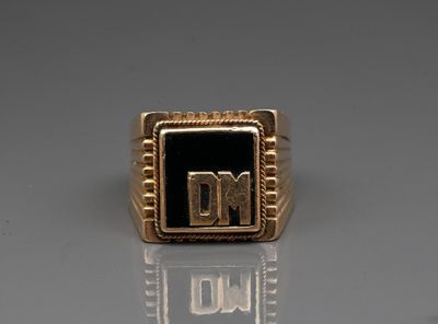 an image of a gold ring with the letter dm on it