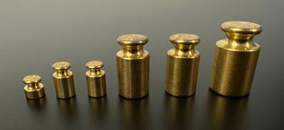 a close up of a group of brass knobs on a table