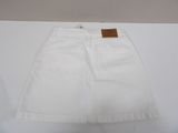 a white skirt with a brown label on the side