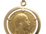 a close up of a gold coin with a man ' s face on it