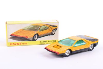 a yellow toy car in front of a boxed box