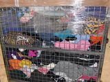 a cart full of clothes sitting in a warehouse
