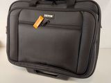 a black suitcase with a tag on it sitting on a table
