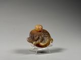 an image of a small carved elephant on a clear stand