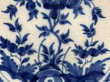 a blue and white plate with a flower design on it
