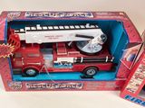 a toy fire truck in the box and a toy fire truck in the box
