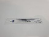 a close up of a pen sitting on top of a white table