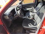 the interior of a small car with a steering wheel and a dashboard