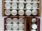 a box full of empty white cups on a table