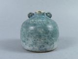 a blue vase with two handles on a white surface