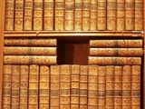many books that are on the shelves in the room